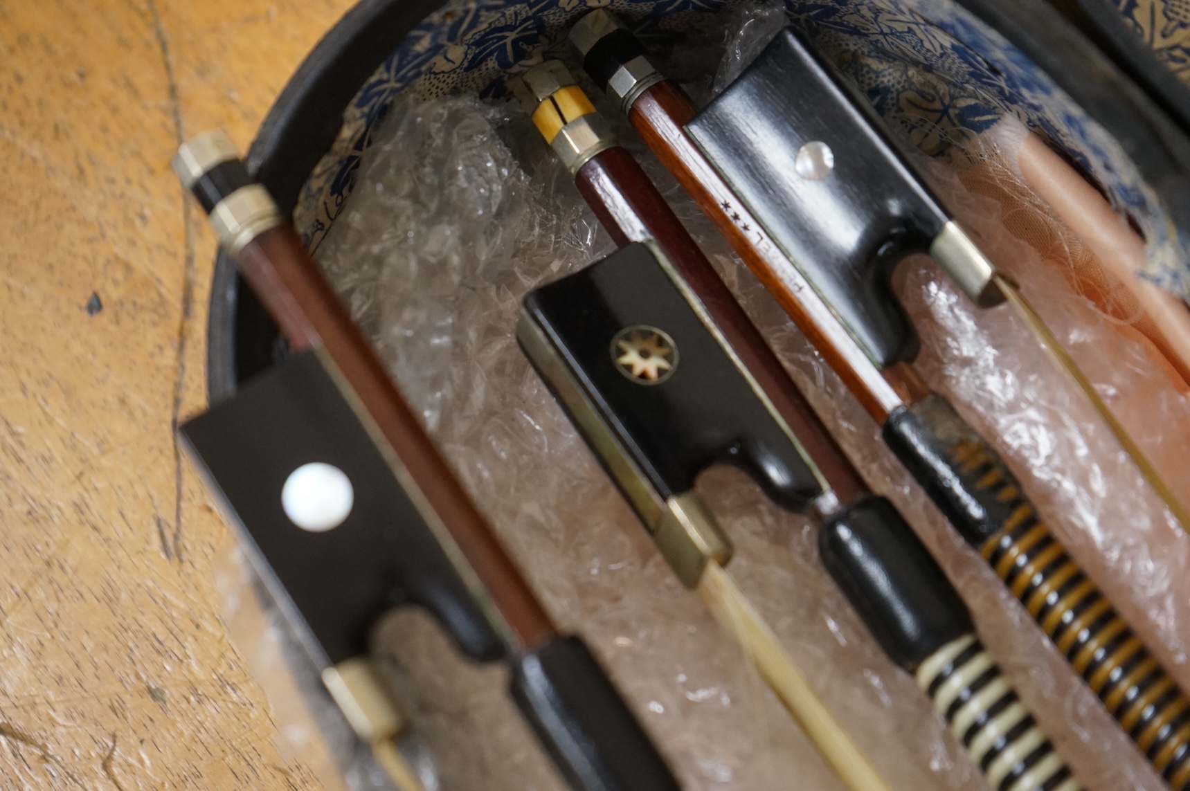 Three German violin bows; an octagonal stick stamped Penzal, together with another stamped E.L. Herrmann and a further unsigned example, all octagonal sticks and fully mounted with nickel mounts, together with an early 2